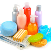 A collection of colorful bath and body care products including liquid hand soap, body wash bottles, and bar soaps available for low MOQ private label.