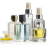 Luxury glass perfume spray bottles in various shapes for custom fragrance manufacturing and private label perfume lines.
